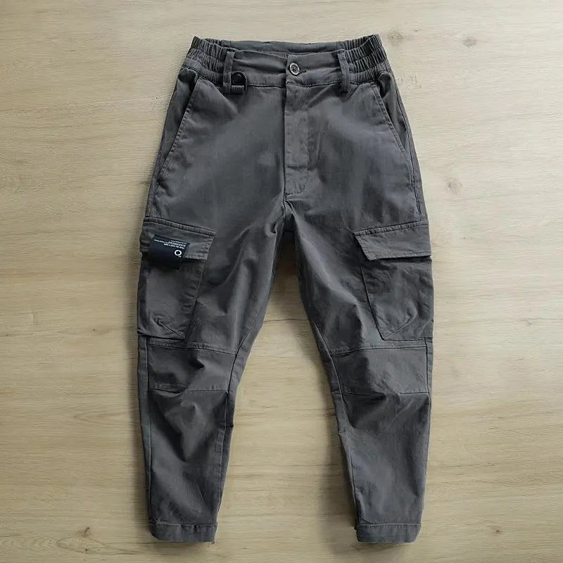 Dark gray cargo pants on a wooden surface
