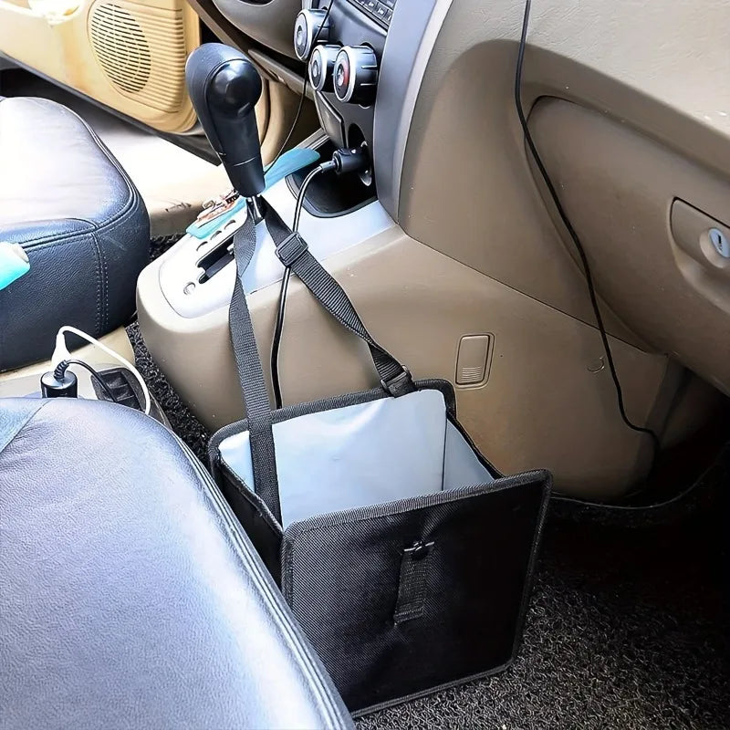 Car organizer attached to a car seat with a phone inside, placed on the floor.