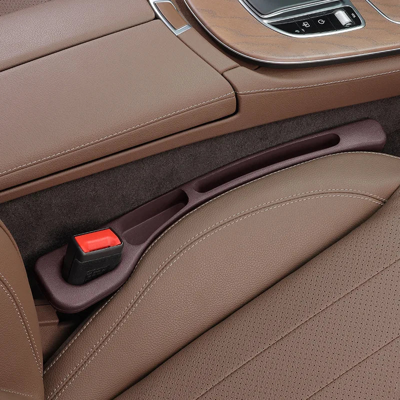 Close-up of a car's brown leather interior with a cup holder.