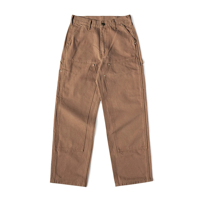 A pair of brown utility cargo pants with side pockets and zippered details, laid flat on a white background.