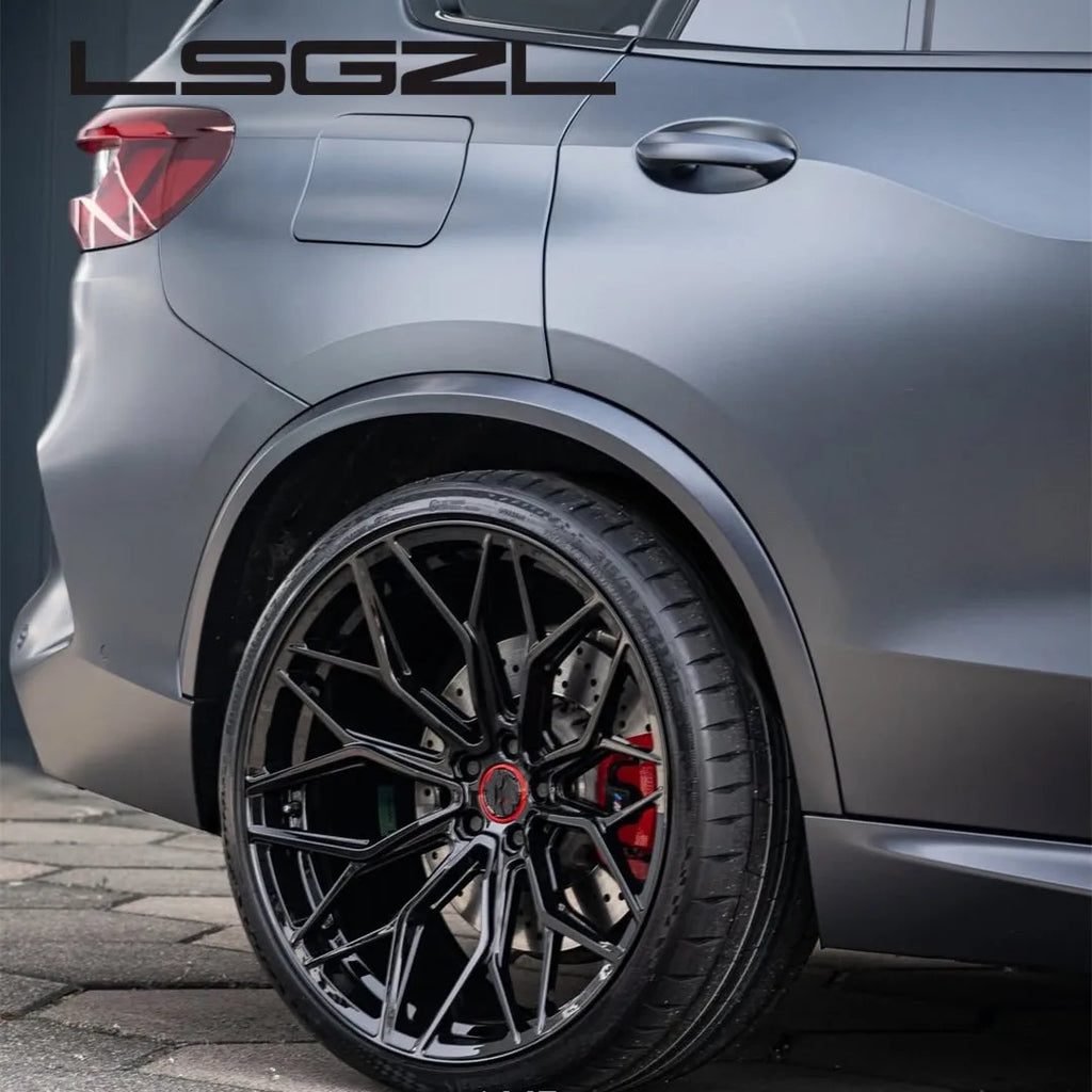 A close-up of a matte black multi-spoke aftermarket car wheel installed on a dark gray SUV, showing the wheel, tire, brake caliper, and part of the vehicle body. The brand name 'LSGZL' is printed in white at the top left.