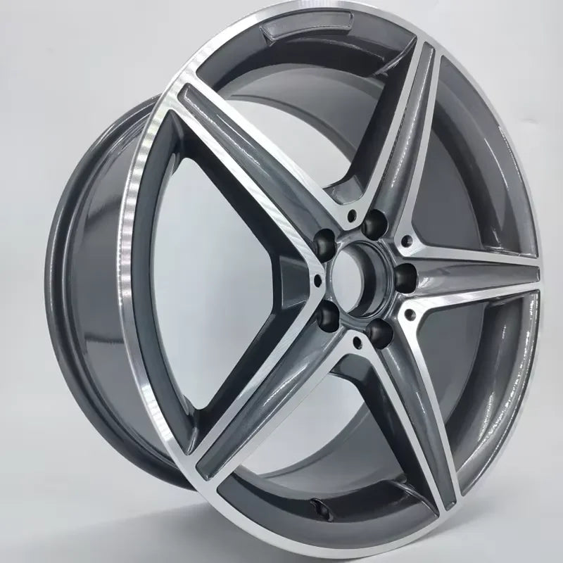A five-spoke alloy car wheel rim with a polished silver outer lip and a dark gray metallic finish on the spokes and inner barrel, shown on a light gray background.