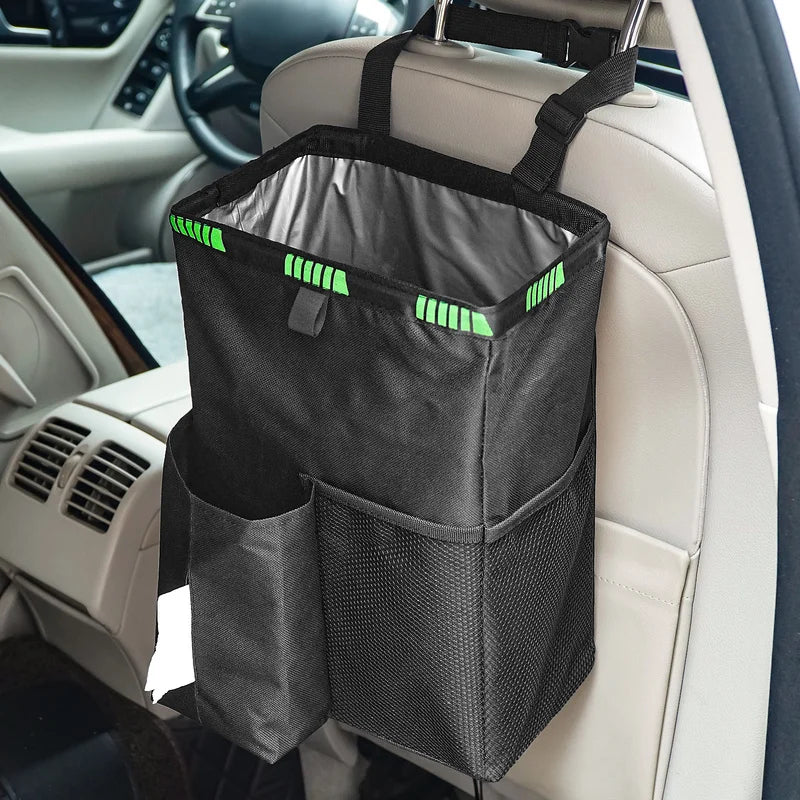 A black car interior storage bag hanging from the back of a car seat, with two front pockets and bright green reflective trim details.