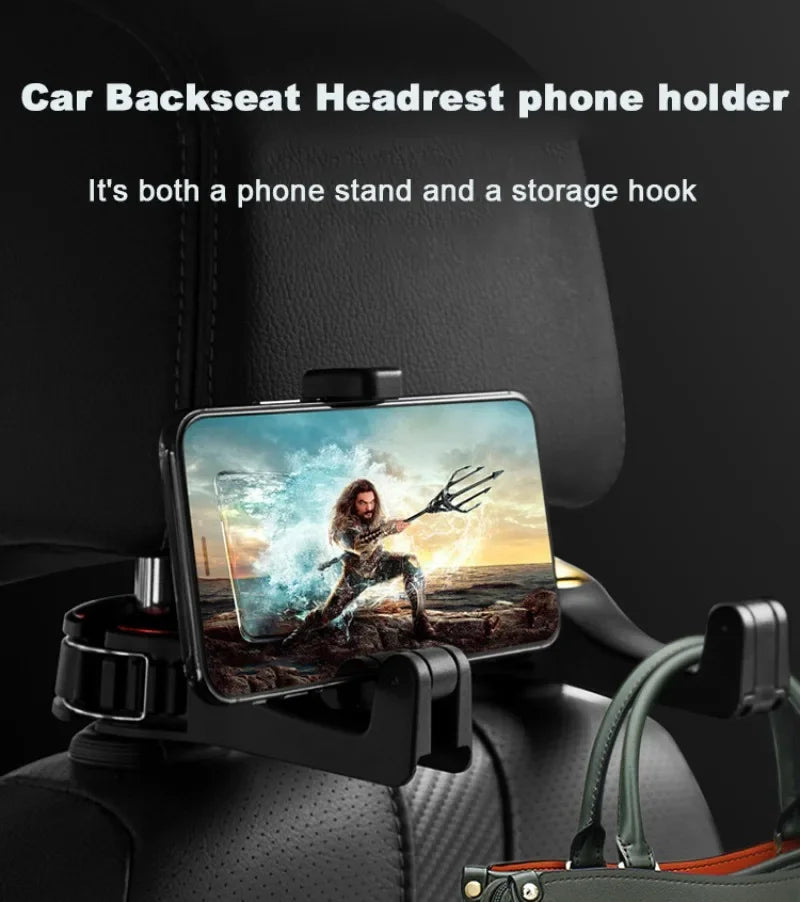 Black car backseat headrest phone holder clip mounted on a car seat, holding a smartphone. White text at the top reads 'Car Backseat Headrest phone holder' and 'It's both a phone stand and a storage hook'.