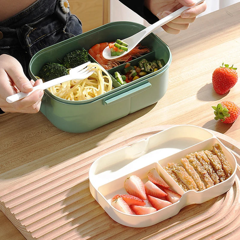 Two bento boxes with food on a wooden table, one being eaten with a fork.