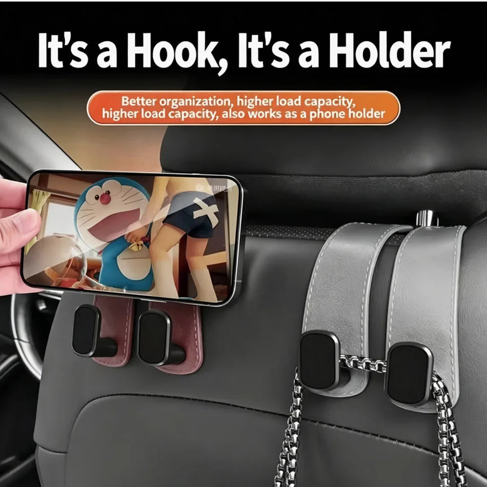 Car phone holder hook mounted on a gray leather car seat backrest, shown holding a smartphone. The product has a gray faux-leather strap with black hook clasps and a silver chain.