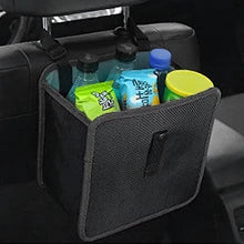 A dark gray mesh car seat organizer bag hanging from a headrest, holding several colorful bottles and containers in a car interior.