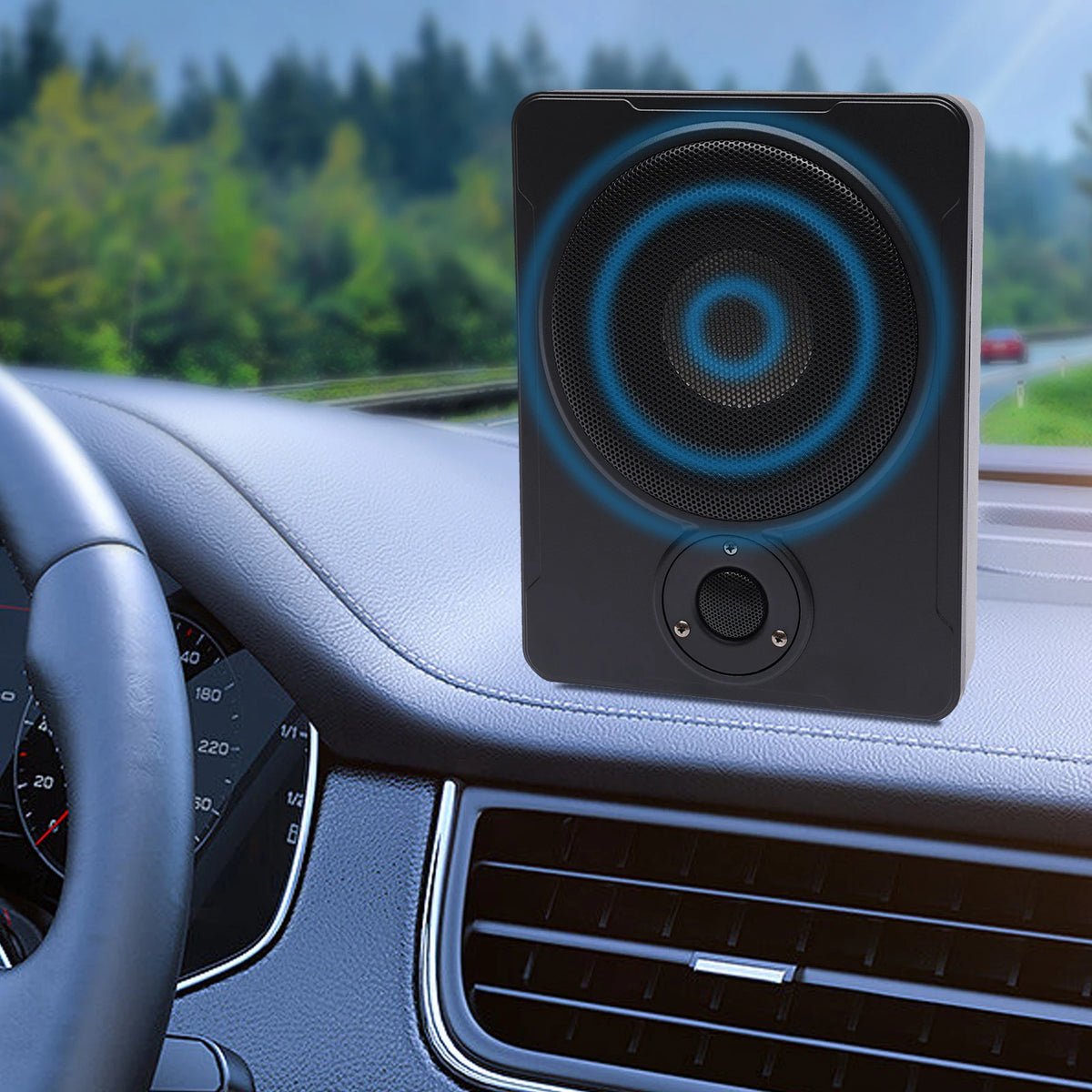 Car speaker mounted on a dashboard with a road and trees in the background

