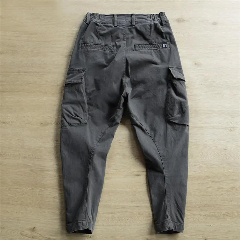 Dark gray cargo pants on a light wooden surface