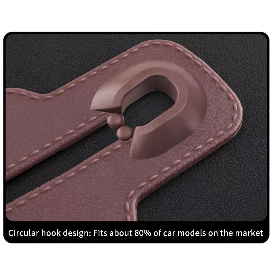 Close-up of a brown leather car accessory with a circular hook design and visible stitching, shown on a dark textured background with explanatory text at the bottom.