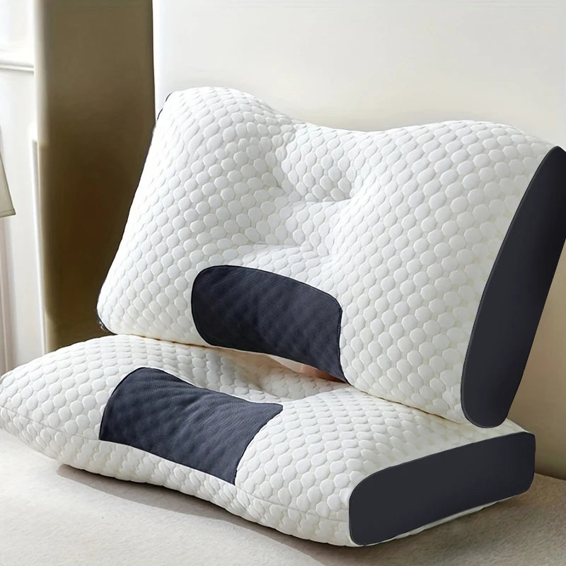 Two white ergonomic memory foam pillows with dark gray side and neck support panels, stacked on a light beige surface.