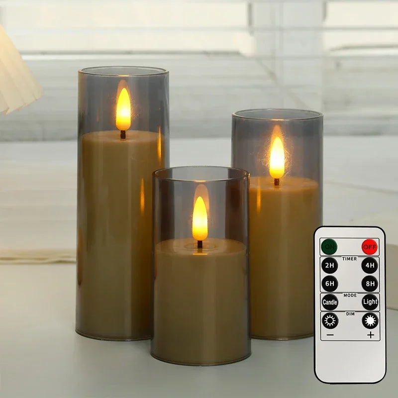 Set of three flameless candles with clear glass holders and a remote control on a light background.