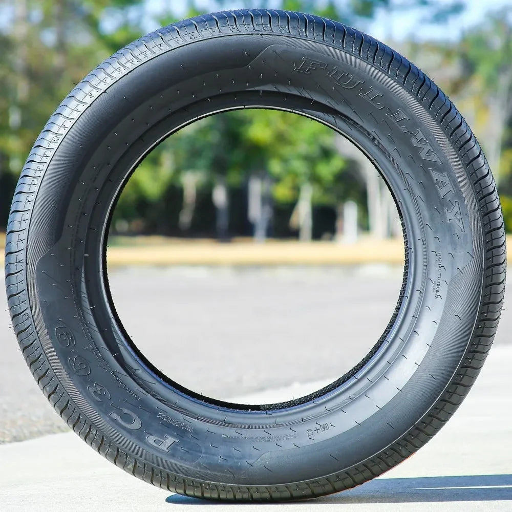 Car tire with visible branding on a blurred natural background
