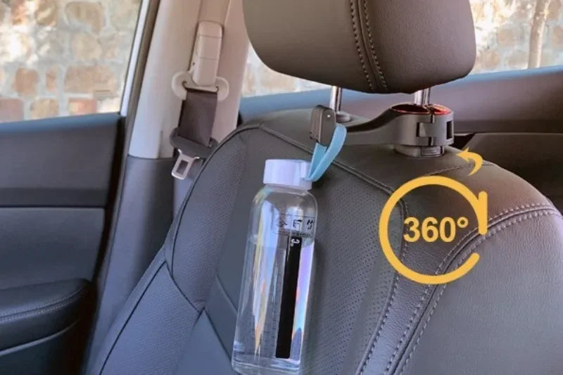 A clear plastic bottle with a white cap hangs from a car headrest using a black and silver clip. The clip is attached to the top of the headrest, and a yellow '360°' graphic overlay is shown on the right.