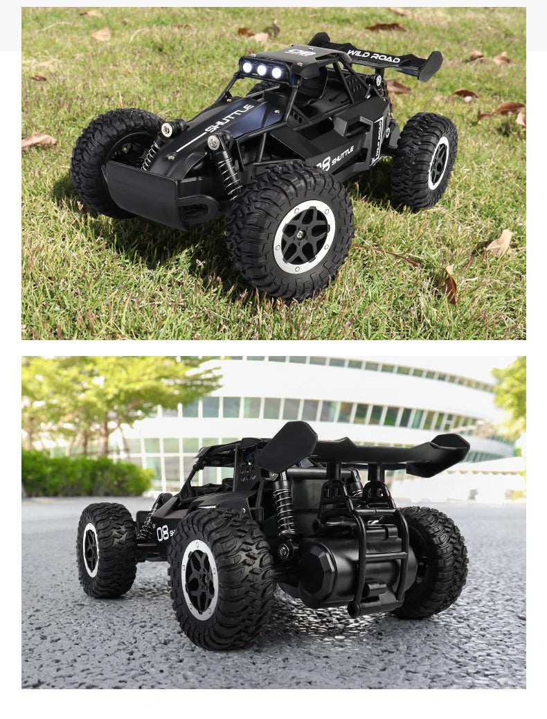 Black remote control car on grass and pavement