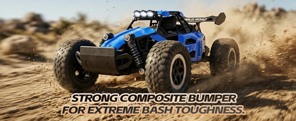 A blue and black remote control off-road buggy driving on a sandy desert track, kicking up dust. Text overlay at the bottom reads 'STRONG COMPOSITE BUMPER FOR EXTREME BASH TOUGHNESS.