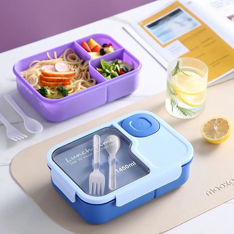 Blue and purple bento boxes with compartments of food on a table.