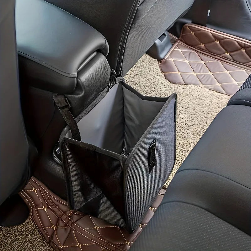 Car seat organizer inside a vehicle with a brown quilted mat on the floor.